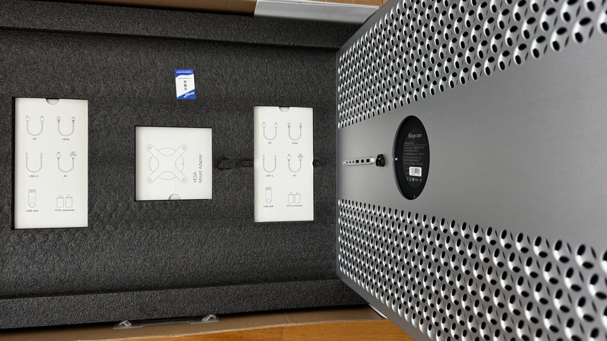 Kuycon P20 protected by foam inside its box